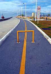 photo of a railing in the middle of a bike path